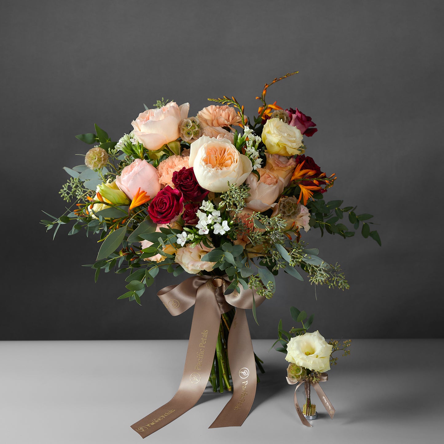 Peach and burgundy bridal bouquet with groom boutonniere