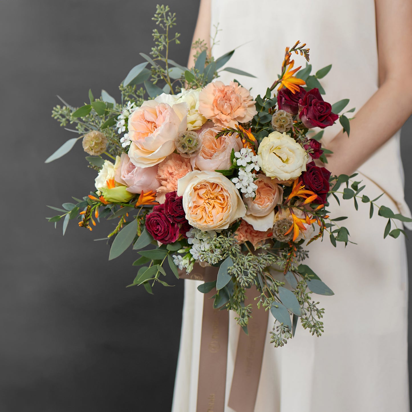 Peach and burgundy bridal bouquet