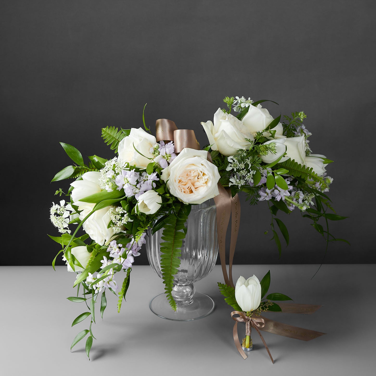 white arrow shaped arm bridal bouquet with groom boutonniere