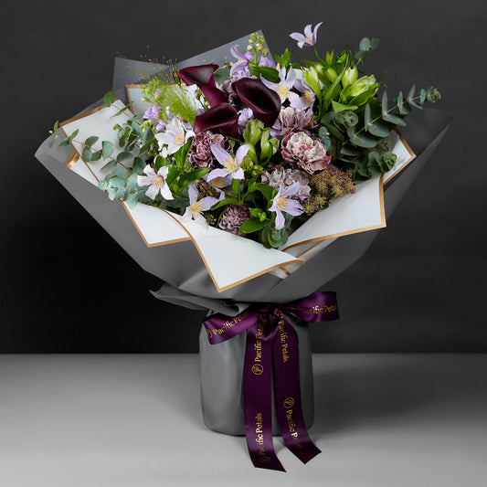 stunning bouquet featuring Purple dyed carnation, calla lily, clematis & Greenery
