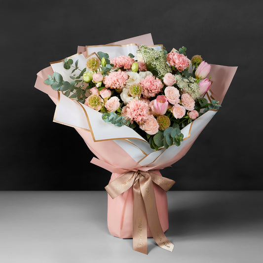 stunning bouquet featuring Brown and pink dyed carnation, tulip, spray rose & Greenery
