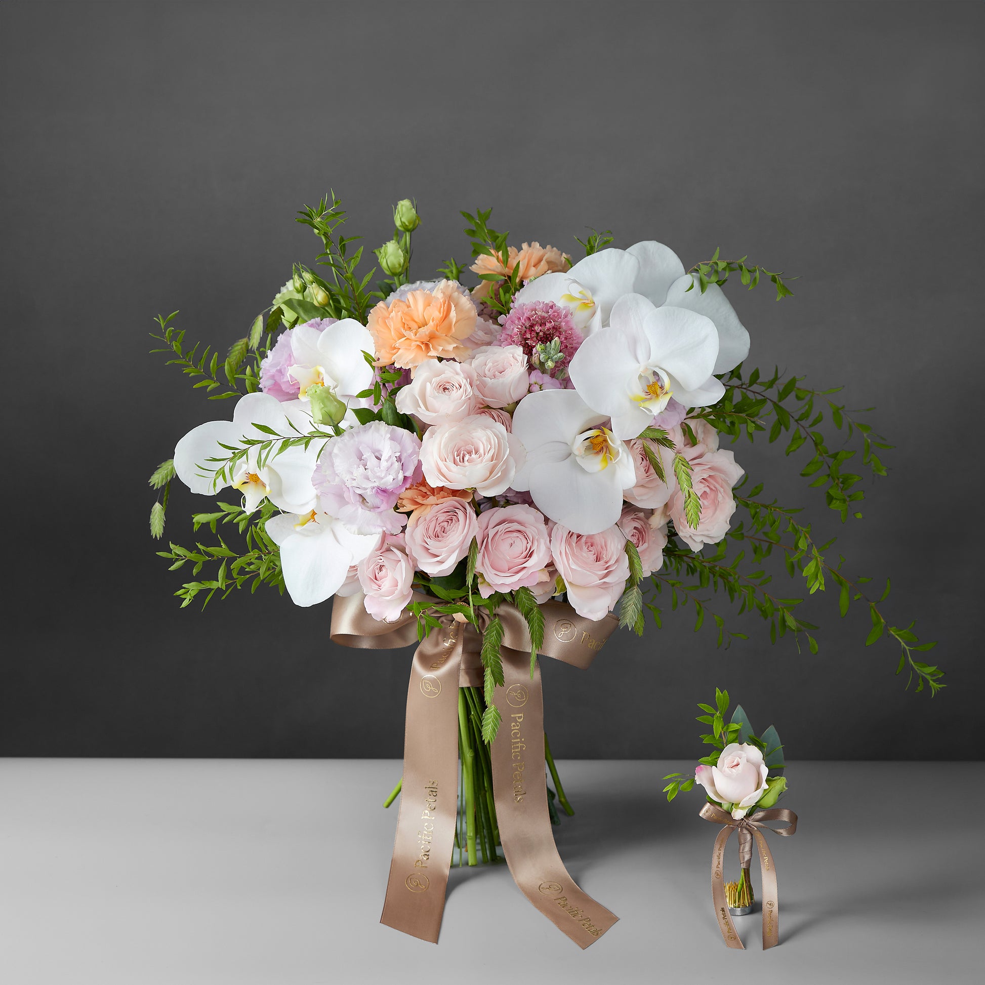 Soft pink and purple bridal bouquet with groom boutonniere